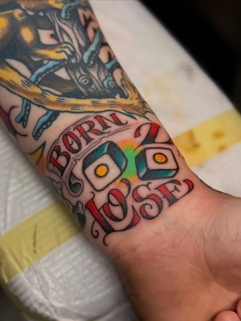 Traditional color lettering tattoo on wrist, Baton Rouge